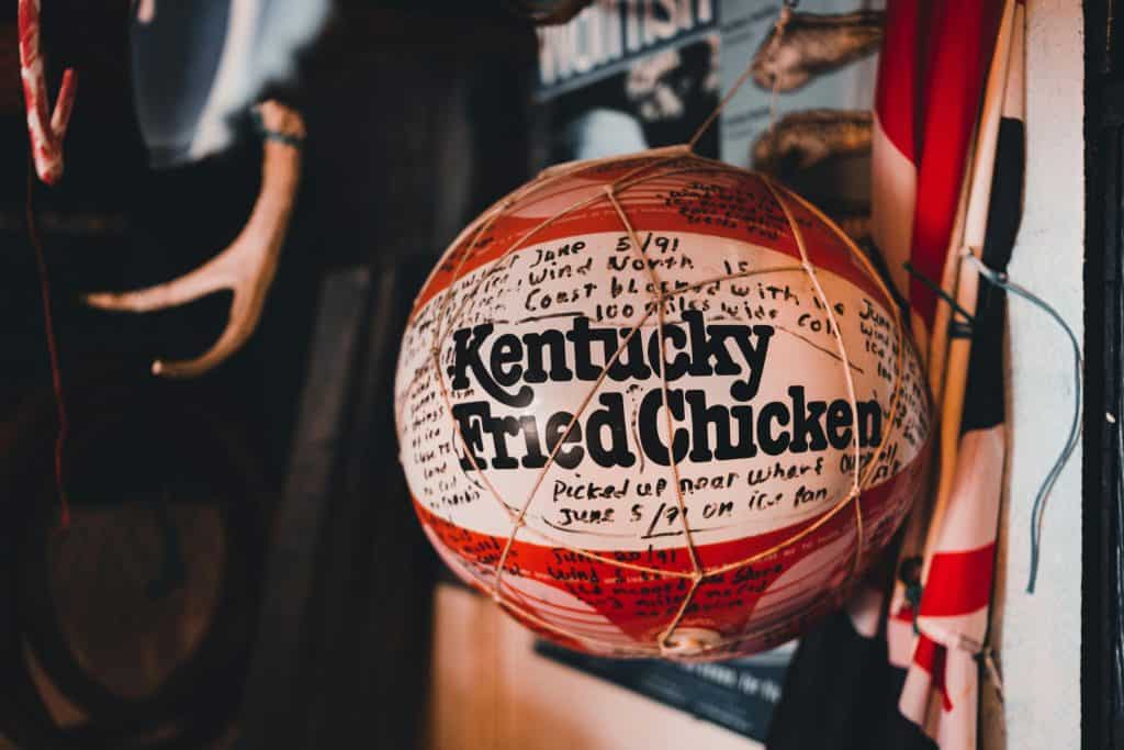 A basketball with Kentucky Fried Chicken logo representing the tradition and legacy of Best Kentucky High School Basketball Players.