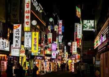 Street in South Korea at night with colorful neon signs, showcasing the vibrant culture and environment of the country known for producing the Best Korean Soccer Players.