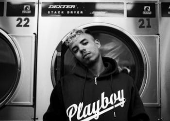 A man standing in front of a dryer numbered 21, representing the theme "Best Soccer Players With Number 21.