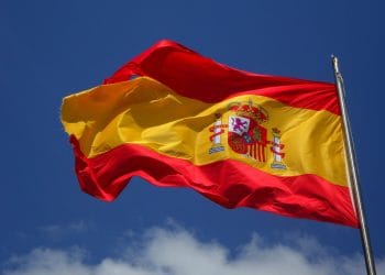 Spanish flag waving in the sky, representing the national pride tied to the Best Valencia Players and their contributions to Spanish football.