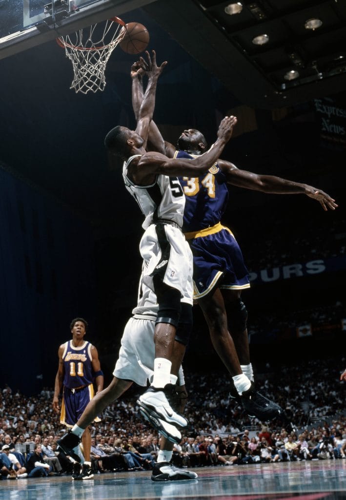 Shaquille O'Neal of the Los Angeles dunking on David Robinson in playoff game. 