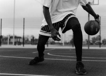 Black and white photo of an NBA player about to perform a crossover dribble, representing the Top 10 Best Ball Handlers in NBA History