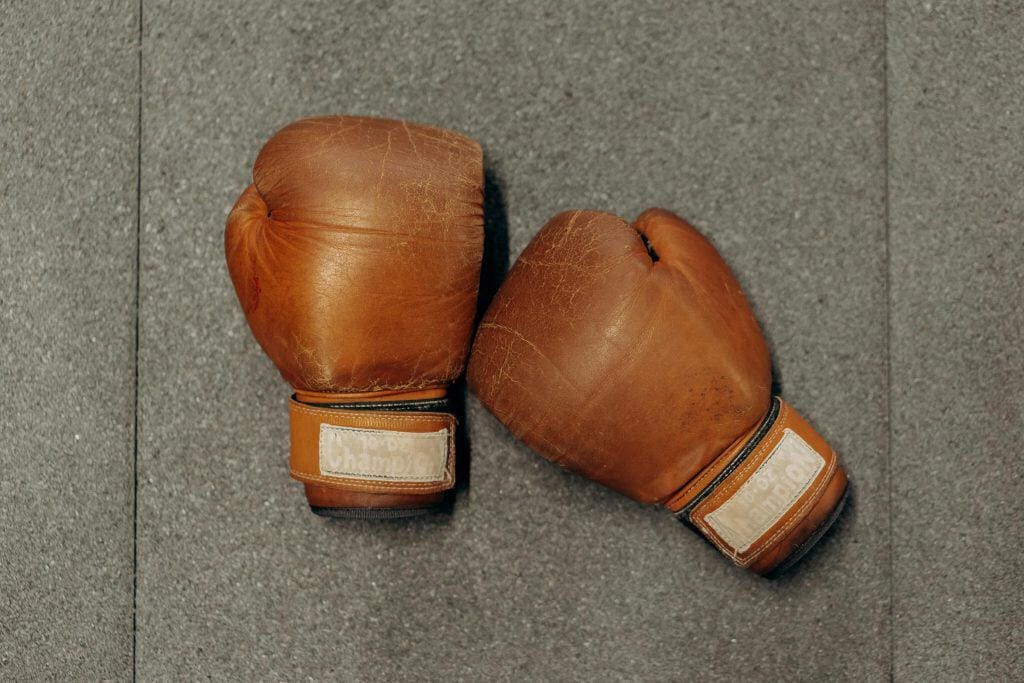 A pair of vintage boxing gloves representing the legacy of Lightweight Boxers, showcasing the history of the division.