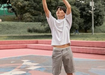 Best Asian Basketball Players of All Time. A young Asian basketball player shooting on an outdoor court, symbolizing top Asian basketball talents.