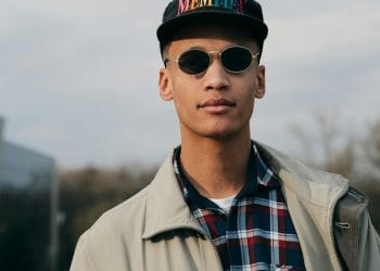 A person wearing a Memphis cap, symbolizing the pride and legacy of the Best Memphis Basketball Players who represented the Tigers.