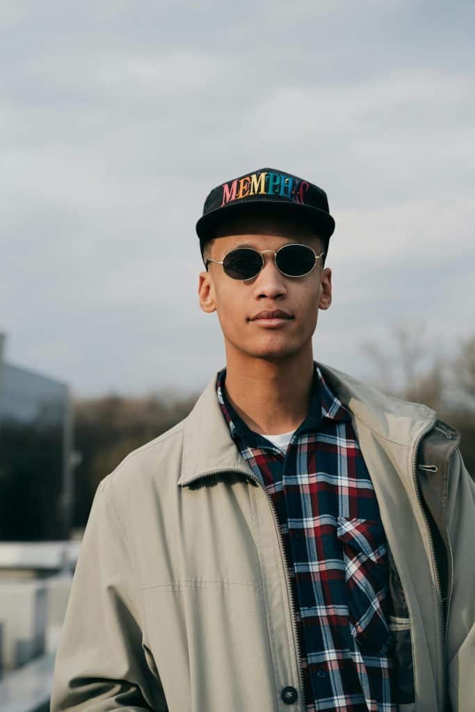A person wearing a Memphis cap, symbolizing the pride and legacy of the Best Memphis Basketball Players who represented the Tigers.
