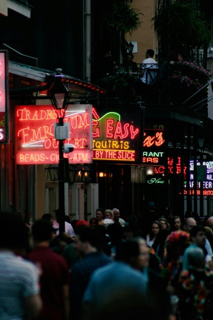 Crowded street scene in Louisiana with neon lights and vibrant nightlife, symbolizing the culture and where Best NBA Players From Louisiana hang out.