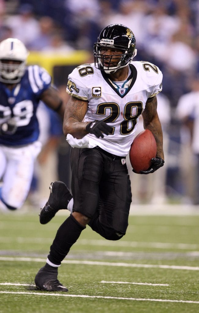 Fred Taylor of the Jacksonville Jaguars carries the football while running downfield during a game