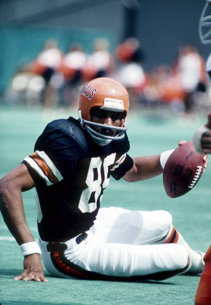 Isaac Curtis of the Cincinnati Bengals sitting on the field holding the football during a game.
