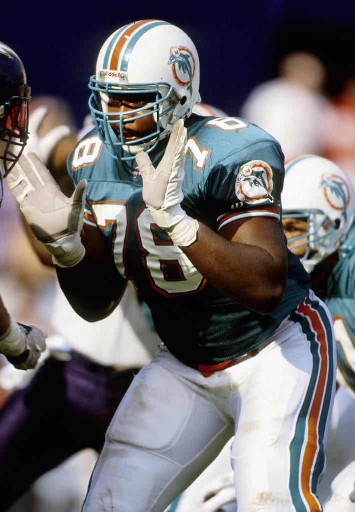Richmond Webb in Miami Dolphins uniform, poised and protecting the quarterback during a game