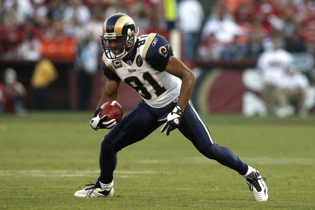 St. Louis Rams wide receiver Torry Holt running with the football during a game, wearing the team’s uniform.