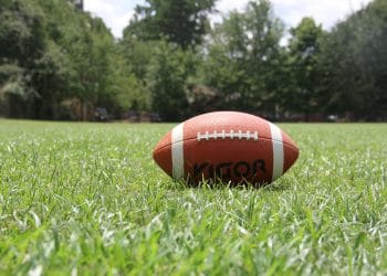 Football resting on a grass field, representing the dedication and talent of the best Arena Football players of all time.