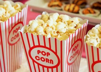 A close-up of popcorn in classic red-and-white striped containers, symbolizing a movie setting for enjoying the best fictional football players on screen