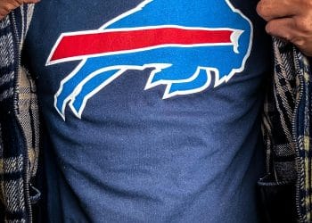 Close-up of a person wearing a Buffalo Bills logo shirt, representing the pride of Bills 11 Best Players of All Time.