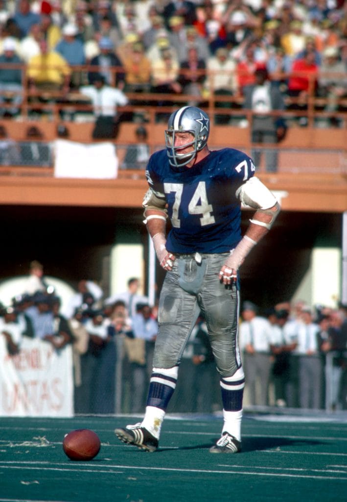 Bob Lilly, Dallas Cowboys defensive lineman, wearing number 74, standing on the field during a game.