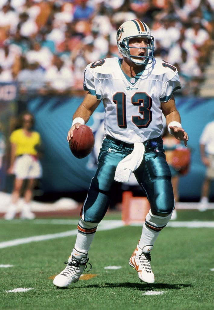 Miami Dolphins quarterback Dan Marino scanning the field for an open receiver.