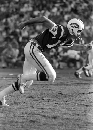 Don Maynard in action on the field wearing his New York Jets uniform, sprinting during a play.