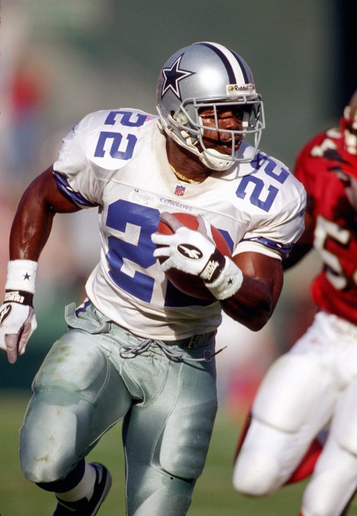 Emmitt Smith of the Dallas Cowboys, wearing number 22, running with the football during a game.
