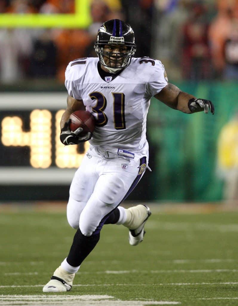 Jamal Lewis running with the ball for the Baltimore Ravens during a game against the Cincinnati Bengals.