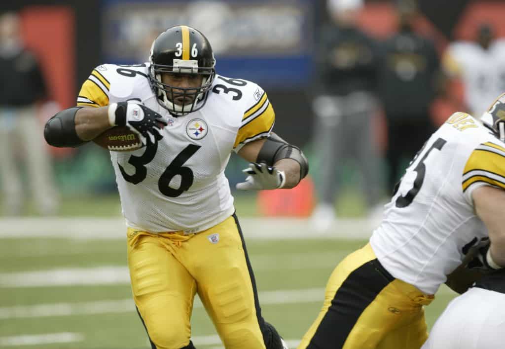 Jerome Bettis running the ball with power during a Pittsburgh Steelers game.