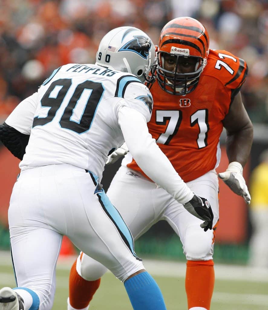 Julius Peppers of the Carolina Panthers facing off against a Cincinnati Bengals offensive lineman during a game.