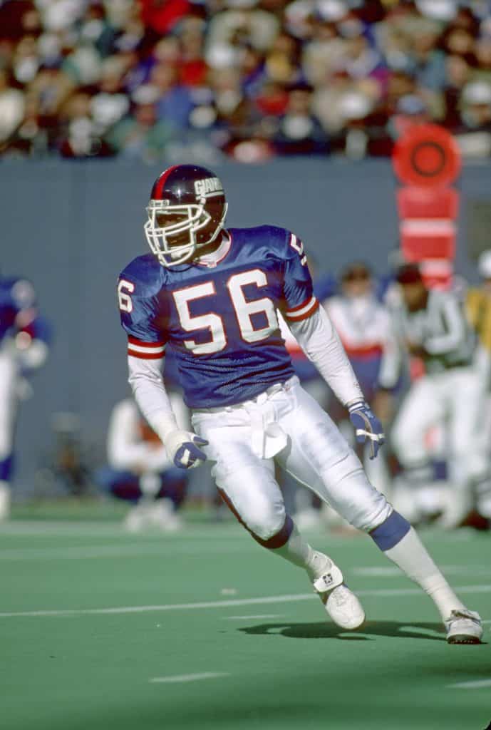 Lawrence Taylor of the New York Giants tracking the play mid-action during a game.