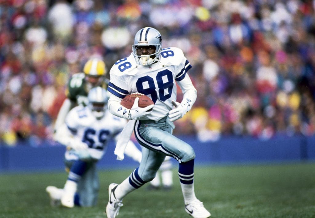 Michael Irvin, Dallas Cowboys wide receiver, sprinting downfield after a catch.