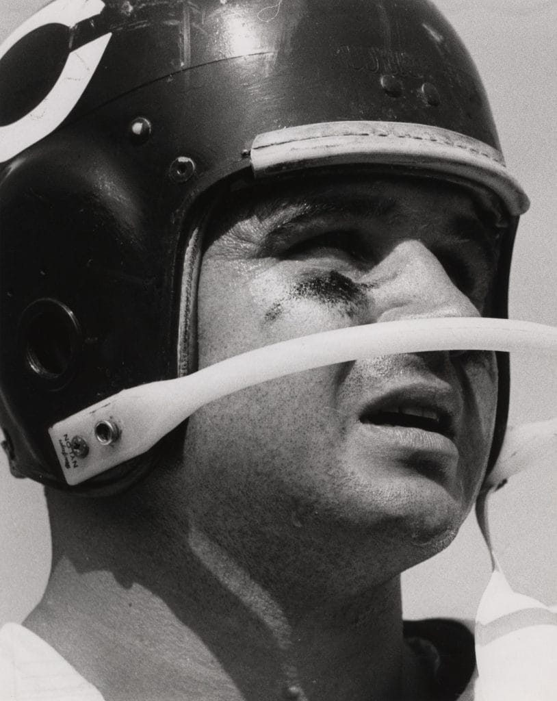 Mike Ditka, Chicago Bears player, close-up wearing his helmet during a game, showcasing a focused expression.