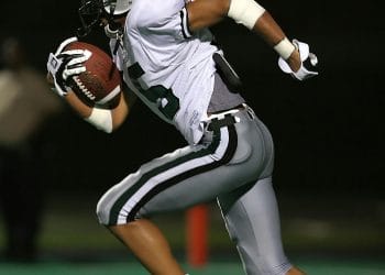 A player sprinting on the field, showcasing the dedication and skill of the Top 10 NAIA Football Teams in college football.
