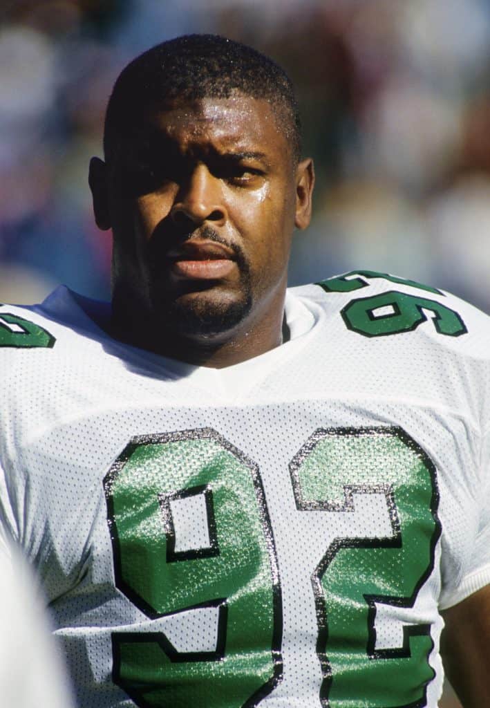 Portrait of Reggie White wearing his Eagles jersey on the field.