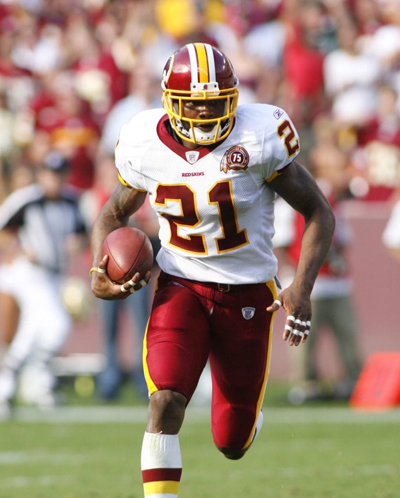 Washington Redskins safety Sean Taylor, number 21, running with the ball during a game.