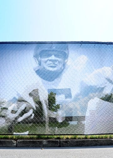 Artistic mural image of Steve Van Buren on a fence.