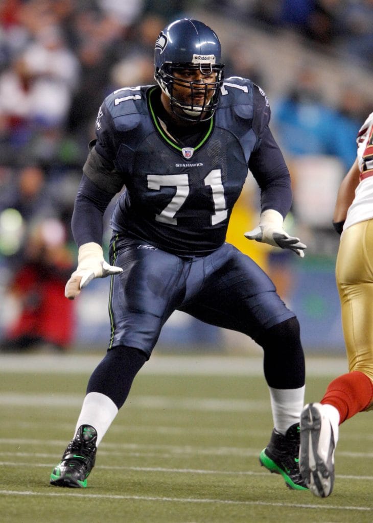 Seattle Seahawks offensive tackle Walter Jones, number 71, in a blocking stance during a game.