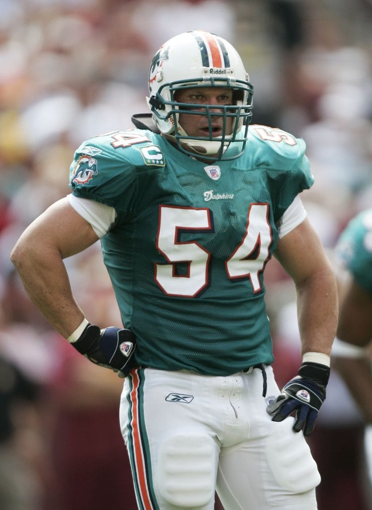 Zach Thomas of the Miami Dolphins standing on the field in full uniform, preparing for a play during an NFL game.