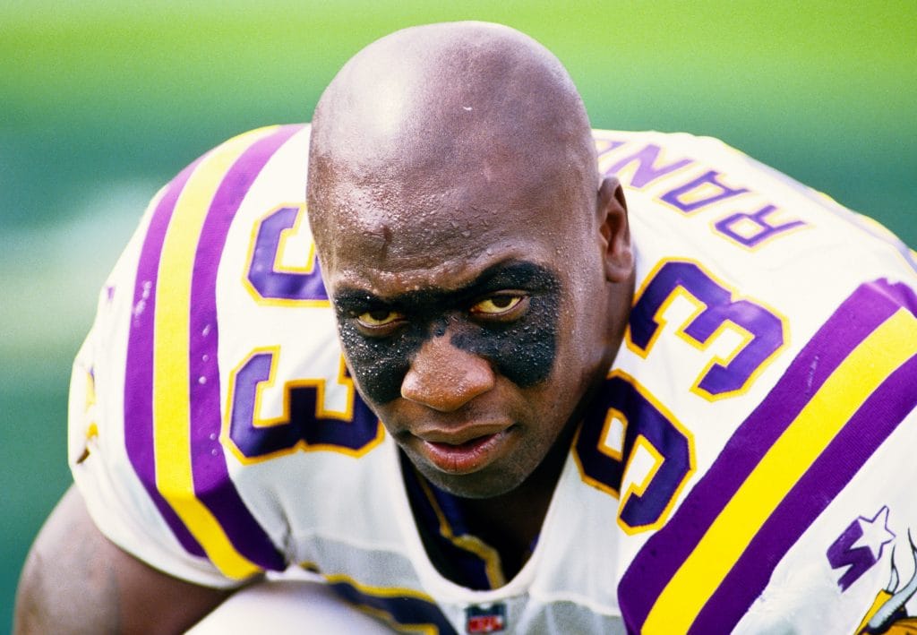 John Randle staring intensely on the sideline in his Minnesota Vikings uniform.
