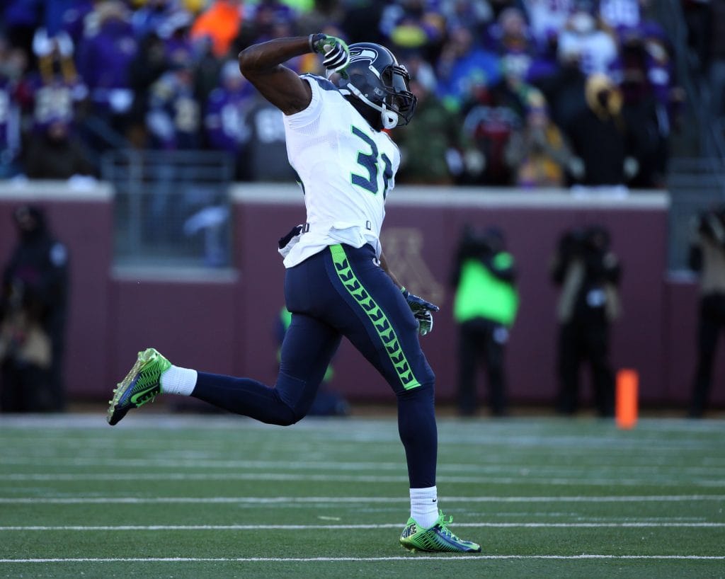 Kam Chancellor of the Seattle Seahawks celebrates after scoring a touchdown during an NFL game.