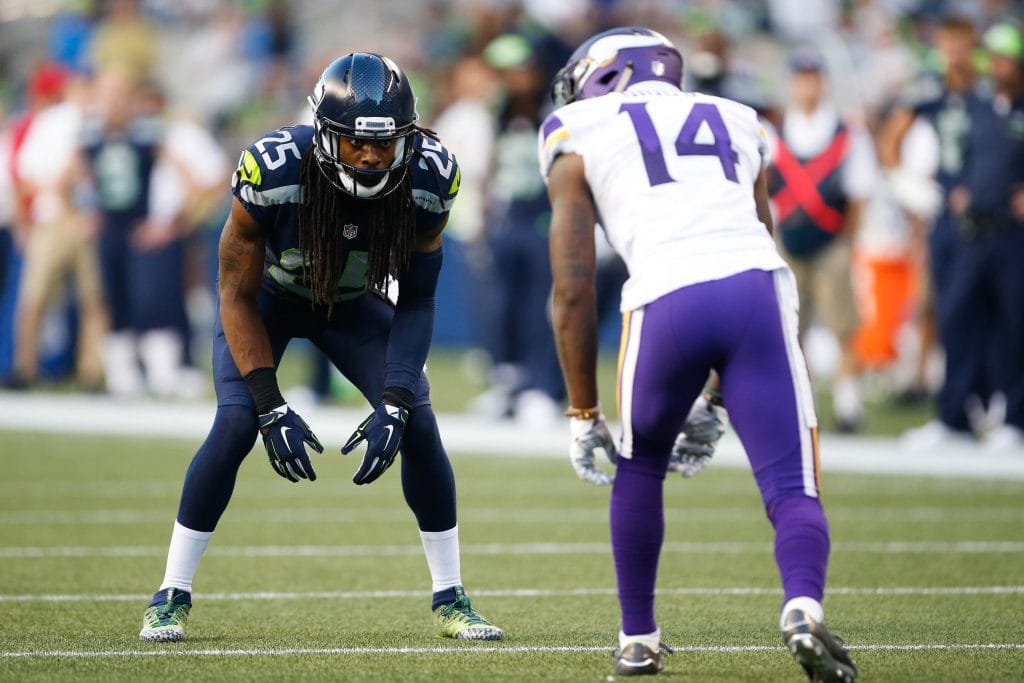 Richard Sherman of the Seattle Seahawks lines up against a Minnesota Vikings wide receiver during a tense matchup.
