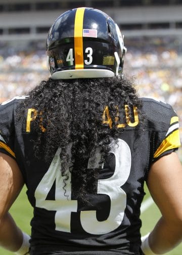 Troy Polamalu of the Pittsburgh Steelers, viewed from behind with his iconic No. 43 jersey and flowing hair.