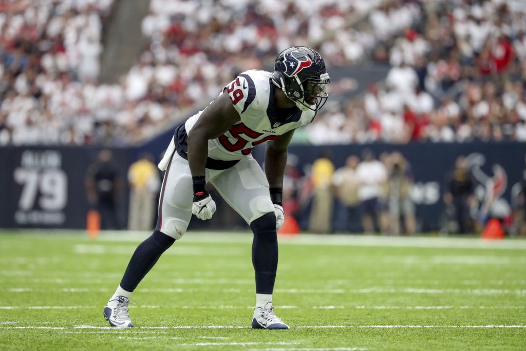 Whitney Mercilus of the Houston Texans lines up in a defensive stance during a game.