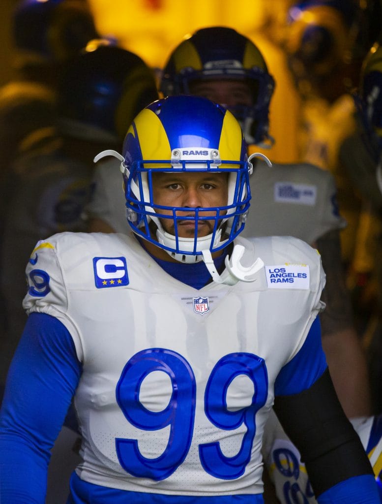 Aaron Donald steps out of the tunnel with fierce determination before a game for the Los Angeles Rams.