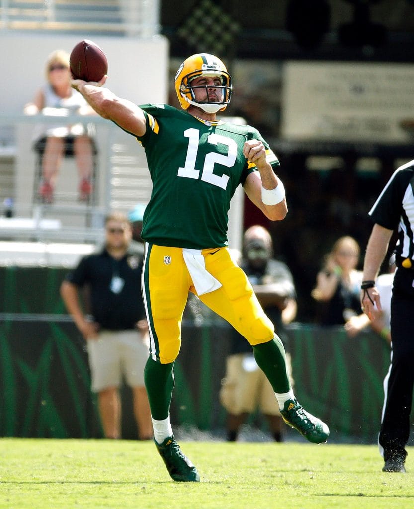 Green Bay Packers quarterback Aaron Rodgers winding up for a pass during a game.