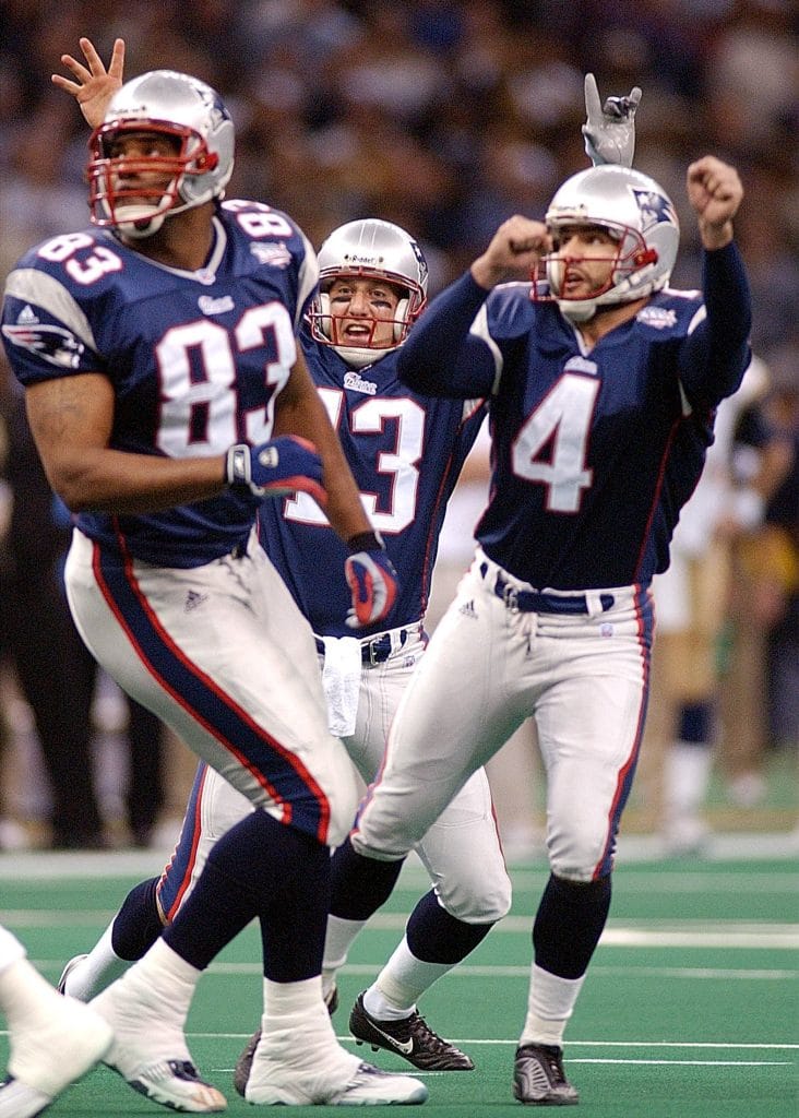 Adam Vinatieri celebrates with teammates after his game-winning Super Bowl field goal for the New England Patriots.