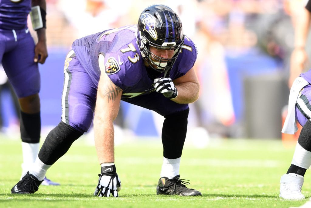 Baltimore Ravens offensive lineman Marshall Yanda preparing at the line of scrimmage during an NFL game.