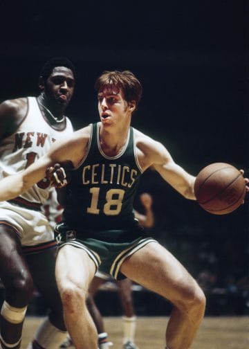 Bill Cowens driving to the basket in a Boston Celtics uniform during a game.