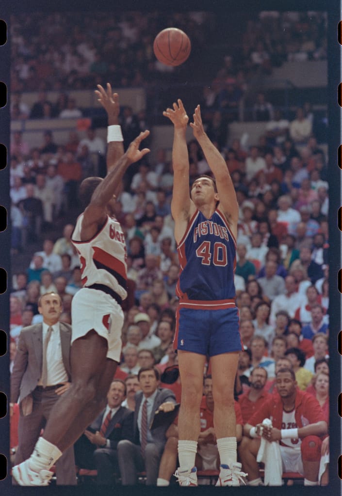 Bill Laimbeer of the Detroit Pistons taking a jump shot during an NBA game over Craig Porter.