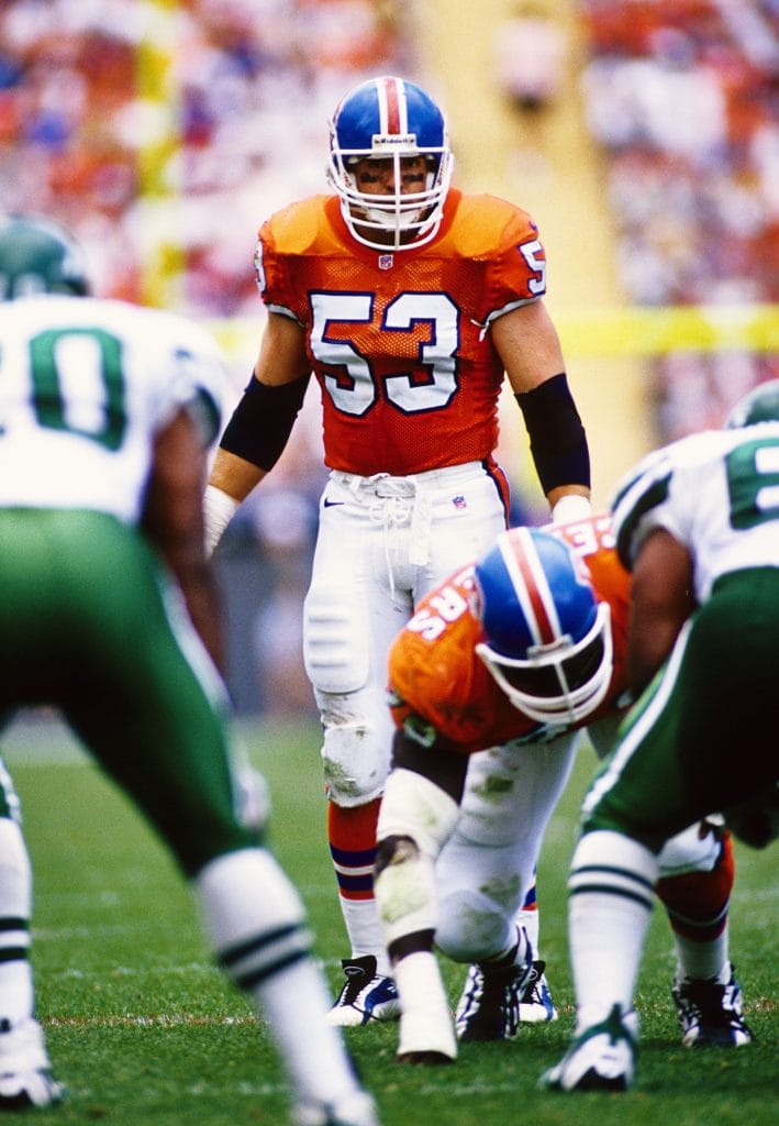 Bill Romanowski lining up as linebacker for the Denver Broncos during a game.