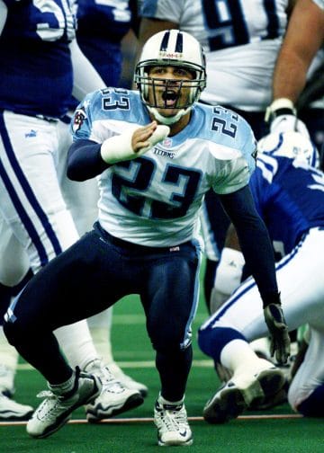 Blaine Bishop celebrates a defensive play during his time with the Tennessee Titans, showcasing his intense energy and impact on the game.