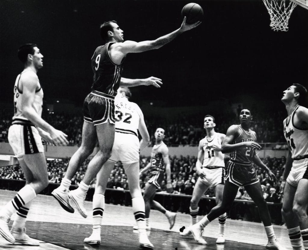 Bob Pettit driving to the basket in a St. Louis Hawks uniform during a game.