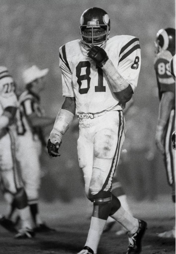 Carl Eller, legendary defensive end for the Minnesota Vikings, standing on the field during a game.