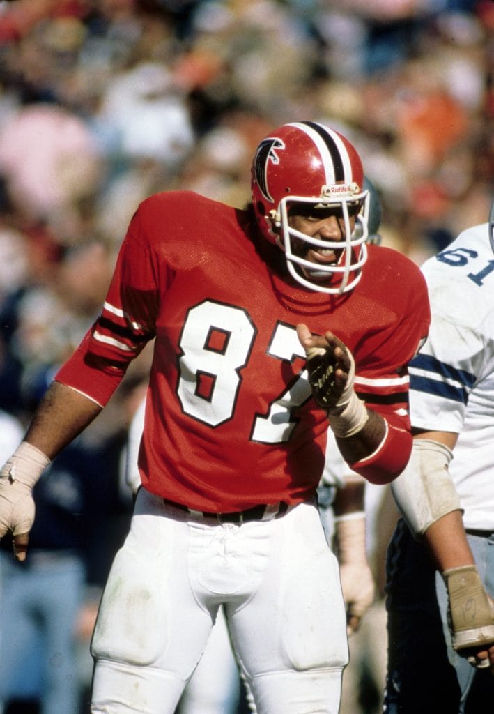 Claude Humphrey of the Atlanta Falcons, wearing jersey number 87, gesturing to teammates during an NFL game.